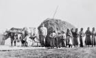 Mission worker and Cree people leading harnessed cows 