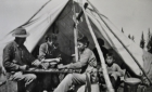 People playing checkers beside a teepee