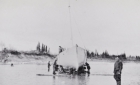 Workers moving a schooner to shore