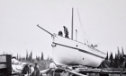 Men moving a schooner out of the water