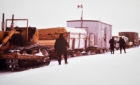 Winter tractor train stopped on the river ice