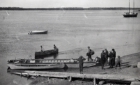 Men loading and boarding a barge