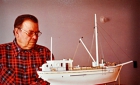 Person viewing a model of a schooner