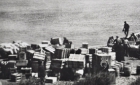 Cree men loading crates off a barge