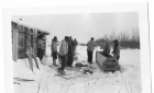 Hunters or trappers at a cabin