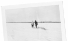 Hunters on snowshoes pulling a toboggan