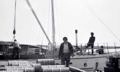 Cree labourers loading fuel drums