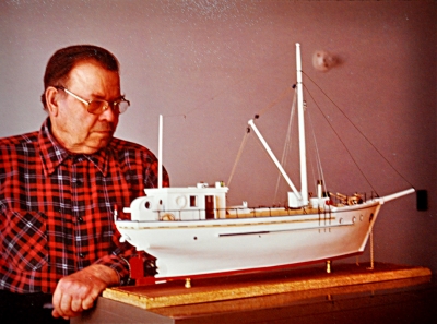Person viewing a model of a schooner